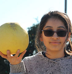 girl holding a melon